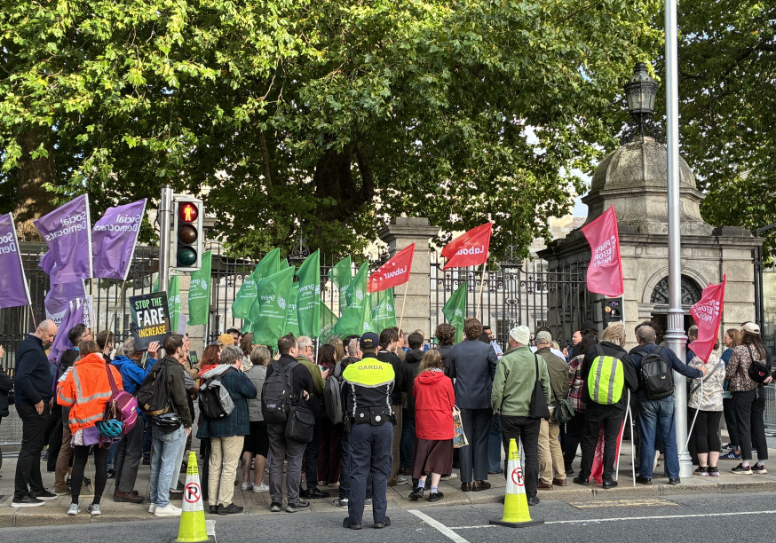 People demonstrating against the fare hikes in front of the Dáil
