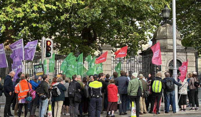 People demonstrating against the fare hikes in front of the Dáil