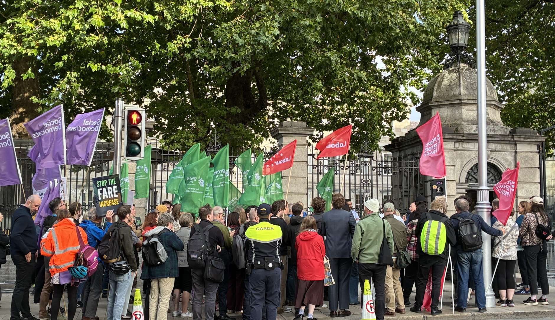 People demonstrating against the fare hikes in front of the Dáil